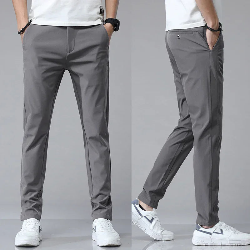 Slim-fit dark gray pants with tapered legs and side pocket detail