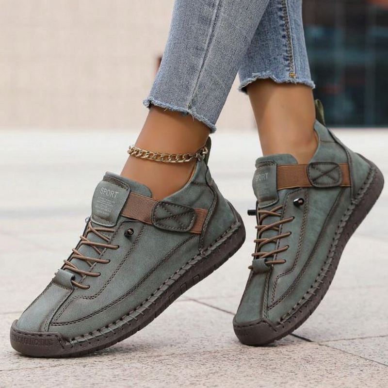 Olive green slip-on trainers with lace-up front and ankle strap, brown accents