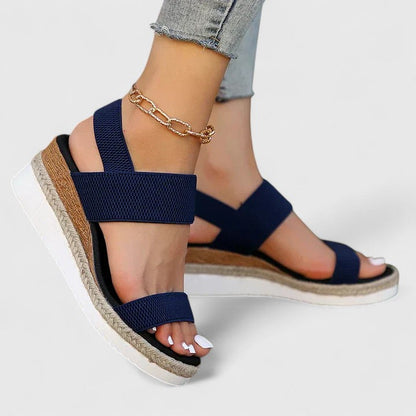 Navy blue comfort sandals with wide straps, espadrille wedge sole, gold chain ankle