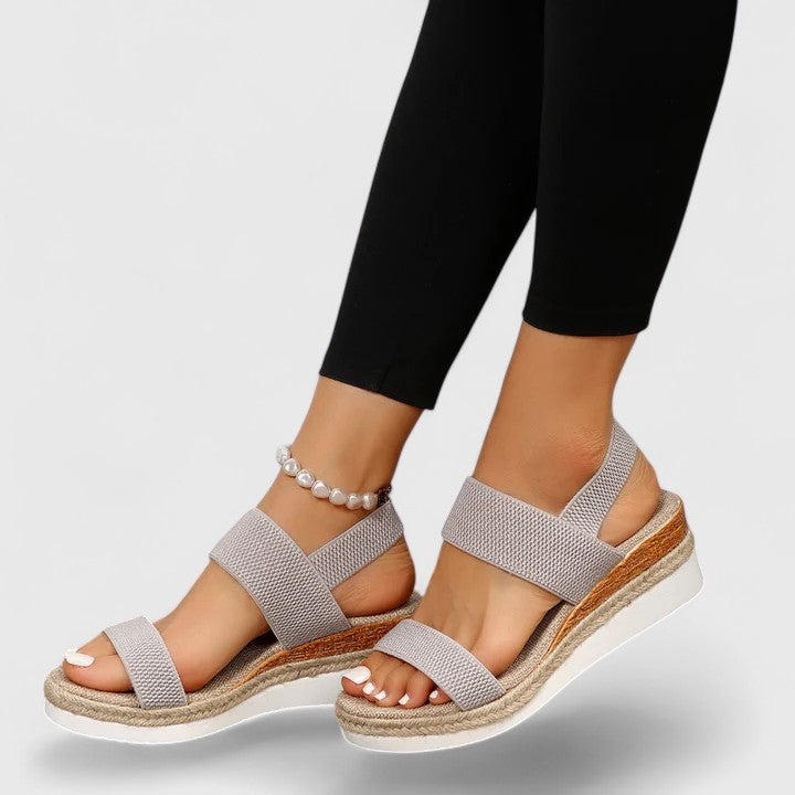 Grey comfort sandals with wide straps and espadrille wedge sole, pearl ankle bracelet