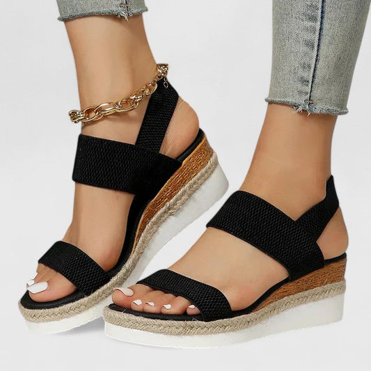 Black comfort sandals with wide straps, espadrille wedge sole, chain ankle strap