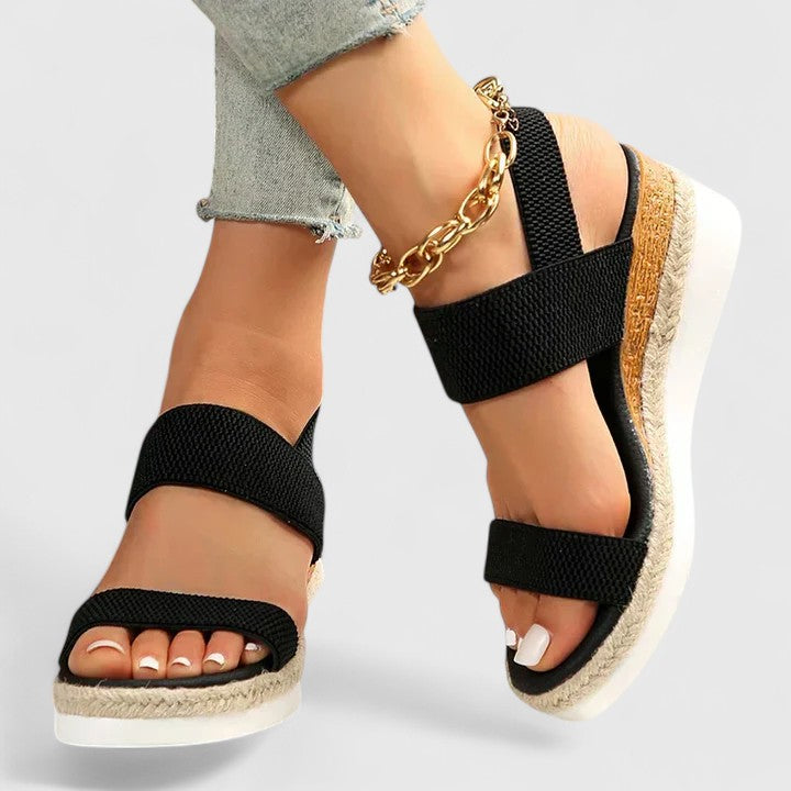 Black comfort sandals with wide straps, espadrille wedge sole, gold chain ankle strap