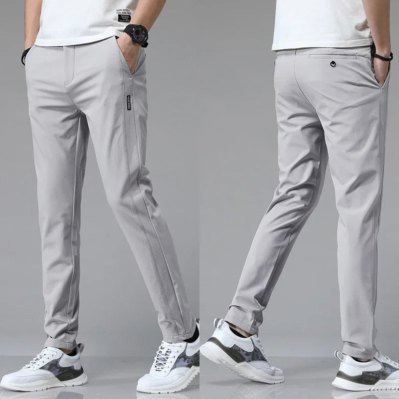 Slim-fit light gray pants with tapered legs and zip side pocket