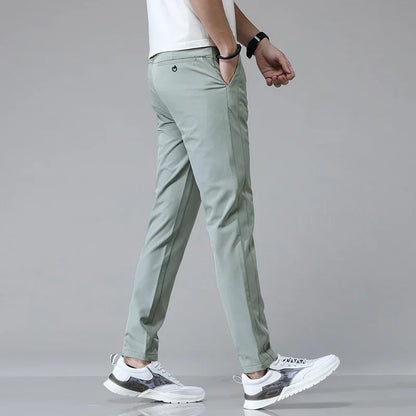 Slim-fit sage green pants with tapered legs and side pockets