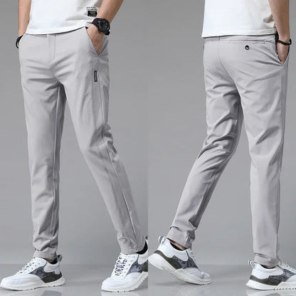 Slim-fit light gray pants with zip fly, button closure, and side pockets
