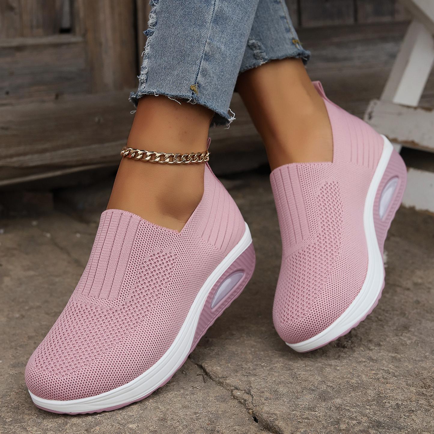 Pink knit slip-on walking shoes with cushioned sole and oval air-cushion window