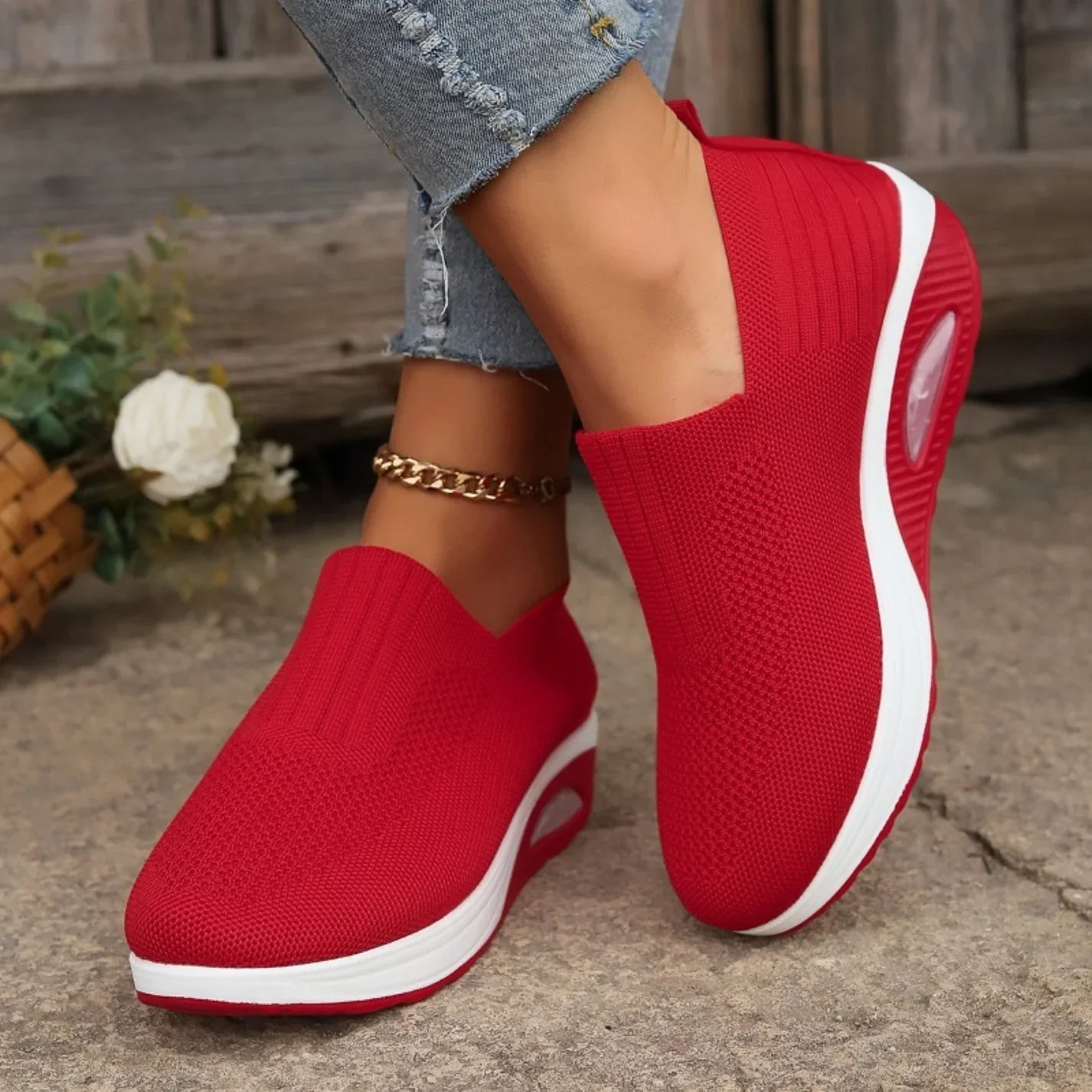 Red knit slip-on walking shoes with cushioned sole and oval air-cushion window
