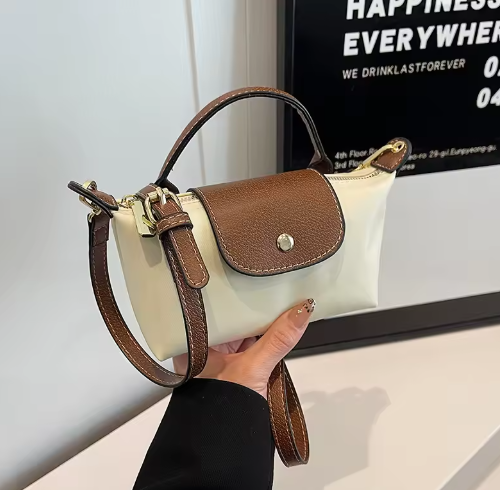 Mini leather pouch, cream with brown textured flap, gold snap, top handle and shoulder strap
