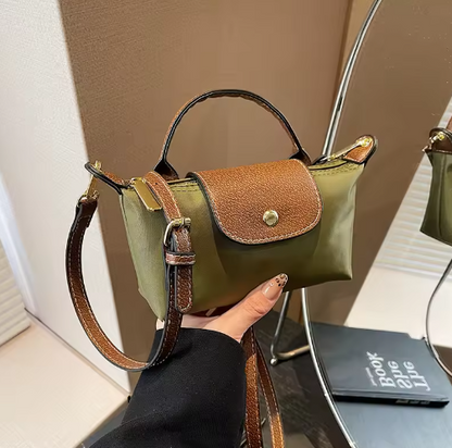 Mini leather pouch, olive green with brown front flap and gold snap, top handle and shoulder strap
