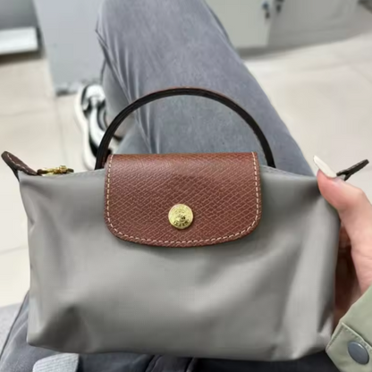 Mini leather pouch, medium gray with brown front flap and gold snap, top handle and strap