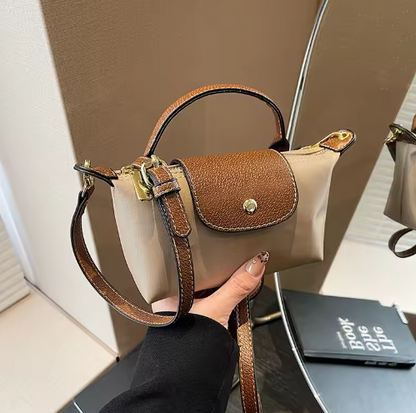 Mini leather pouch with flap, top handle, gold-tone hardware, adjustable strap