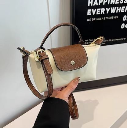 Mini leather crossbody pouch with flap closure and adjustable shoulder strap
