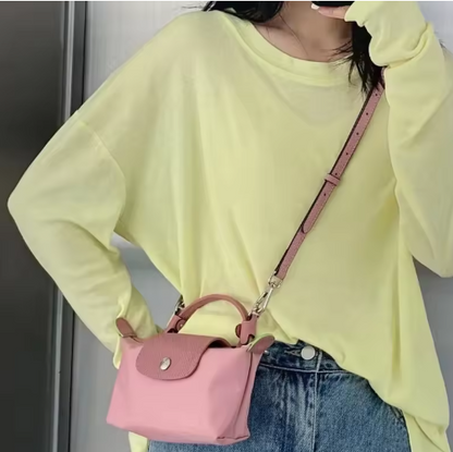 Pink mini leather pouch with flap, silver-tone hardware, crossbody strap