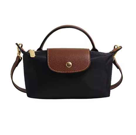 Mini leather pouch, black with brown front flap, gold snap, top handle and shoulder strap