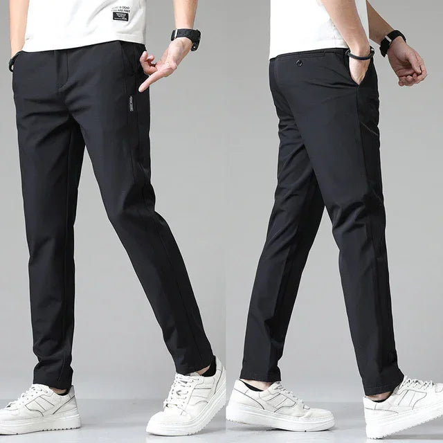 Slim-fit black pants with tapered legs and cuffed ankle hem