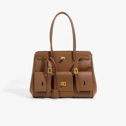 Brown structured handbag with side compartments and gold-tone hardware, three-quarter view