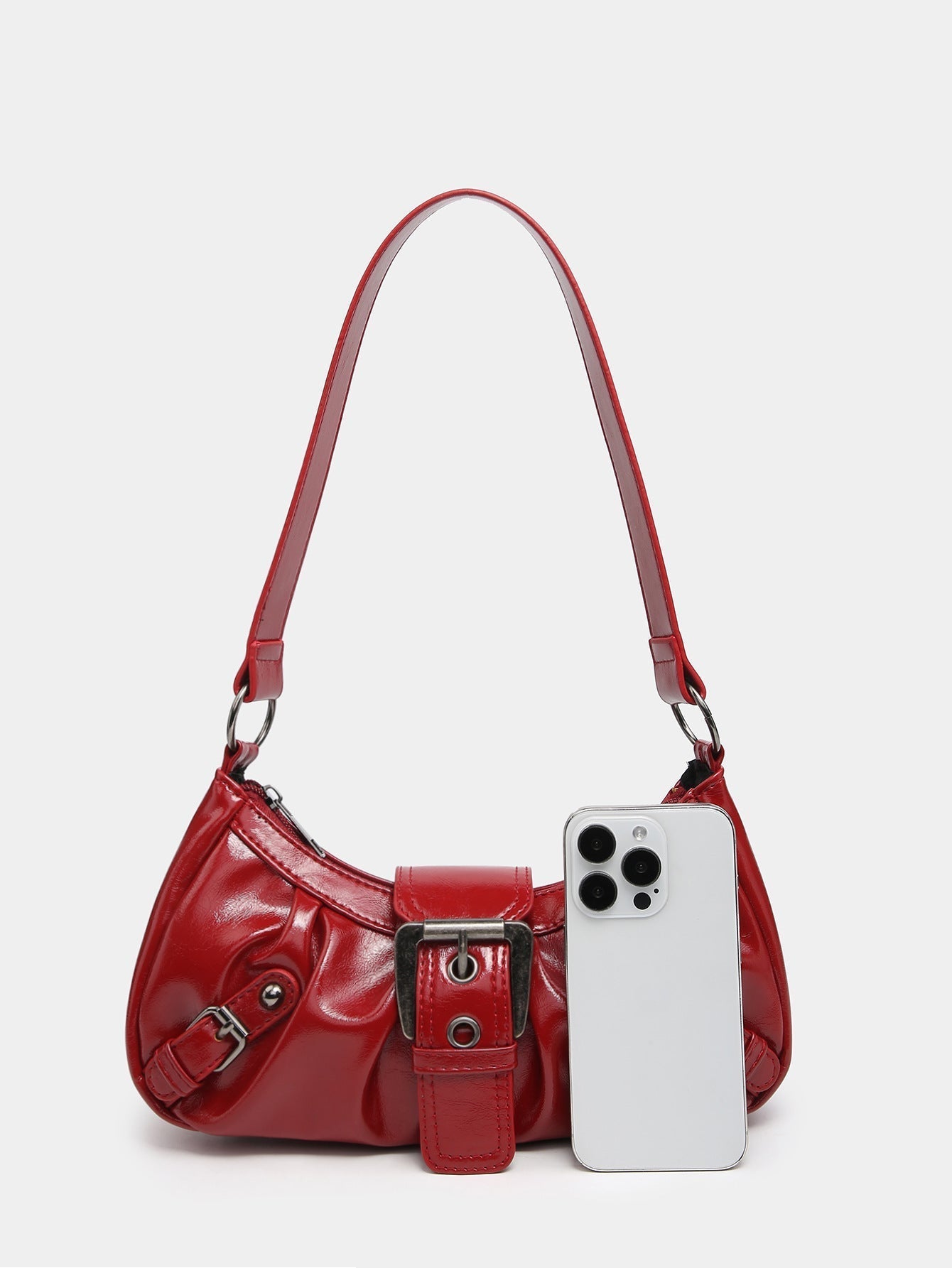 Red faux leather hobo bag with front buckle strap; phone tucked into front pocket