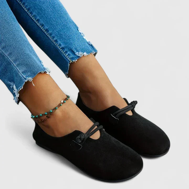 Black slip-on walking shoes with elastic straps and low-profile sole