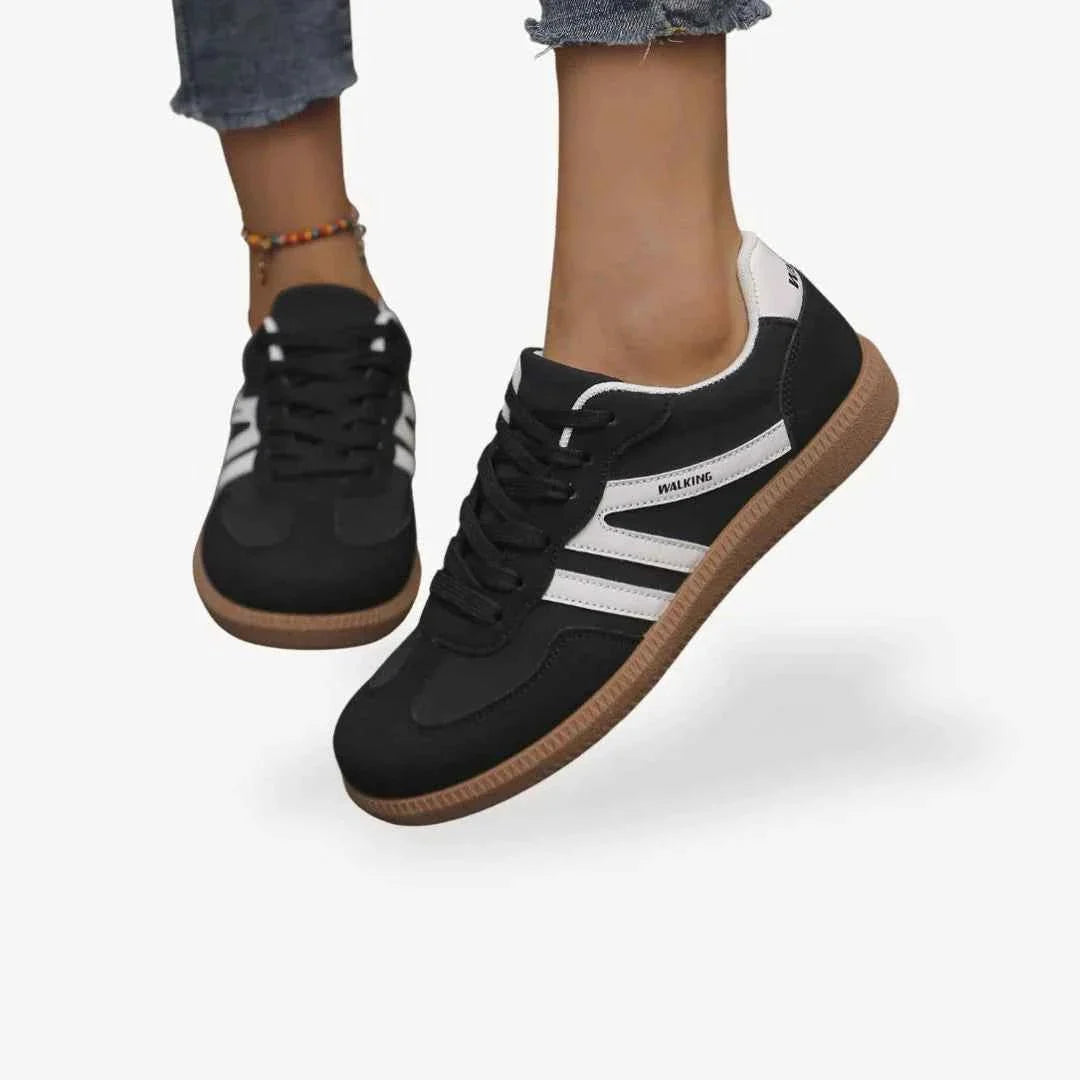 Black comfort trainers with white stripes, lace-up closure and brown gum sole