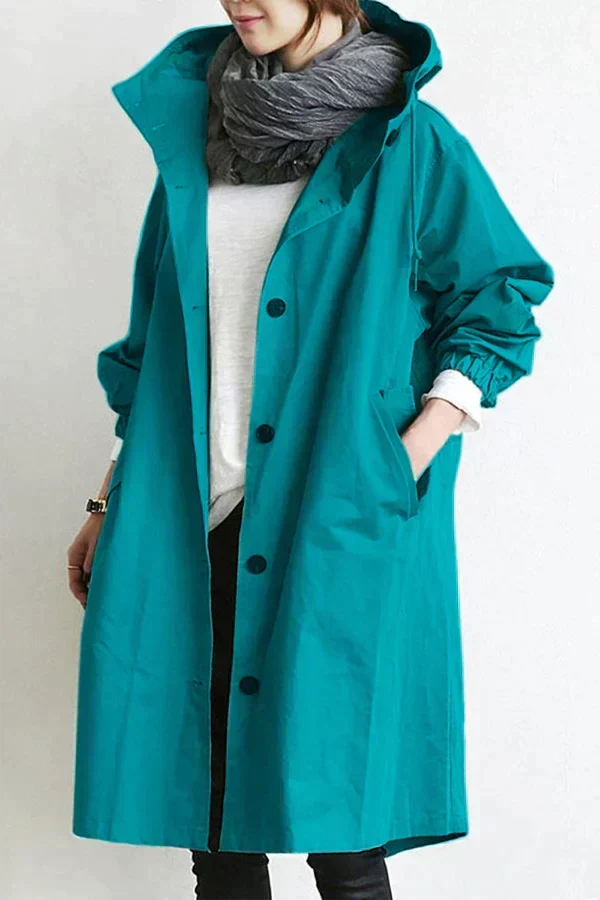 Women's waterproof raincoat with oversized hood, teal color, button front
