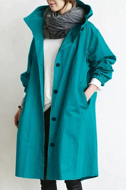Women's waterproof raincoat with oversized hood, teal color, button front