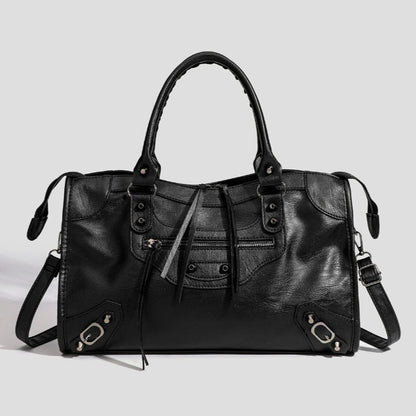 Black vegan leather tote bag with top handles, front pockets, and adjustable strap