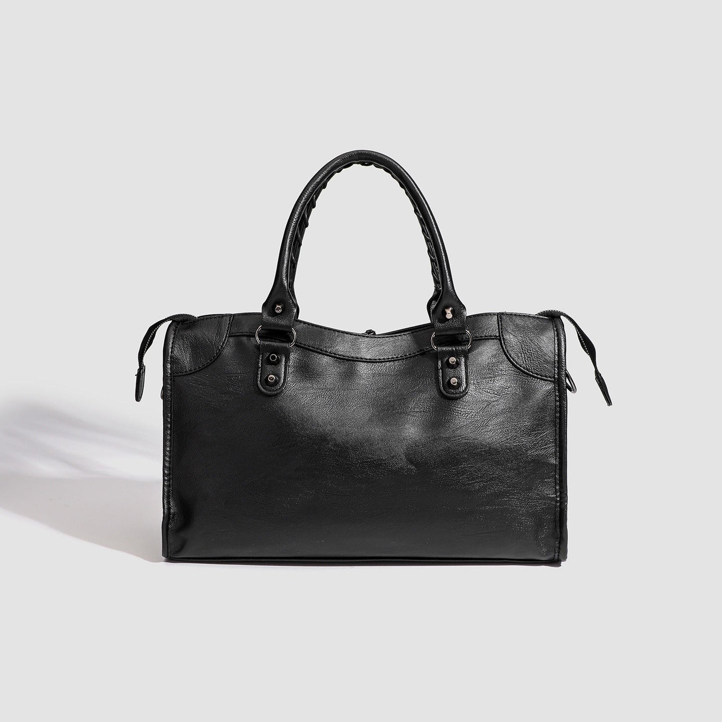 Black vegan leather handbag with top handles and minimal front design