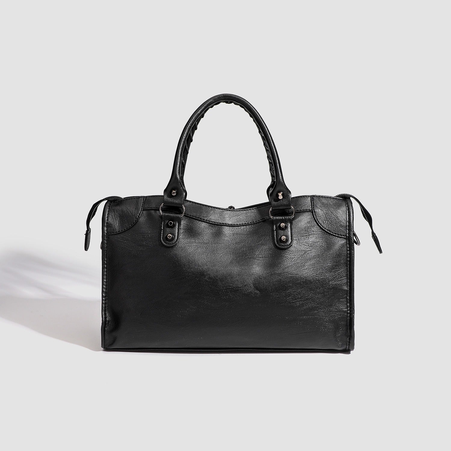 Black vegan leather handbag with top handles and minimal front design