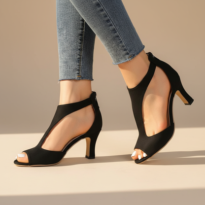 Black supportive heeled sandals with open toe and ankle strap, mid heel