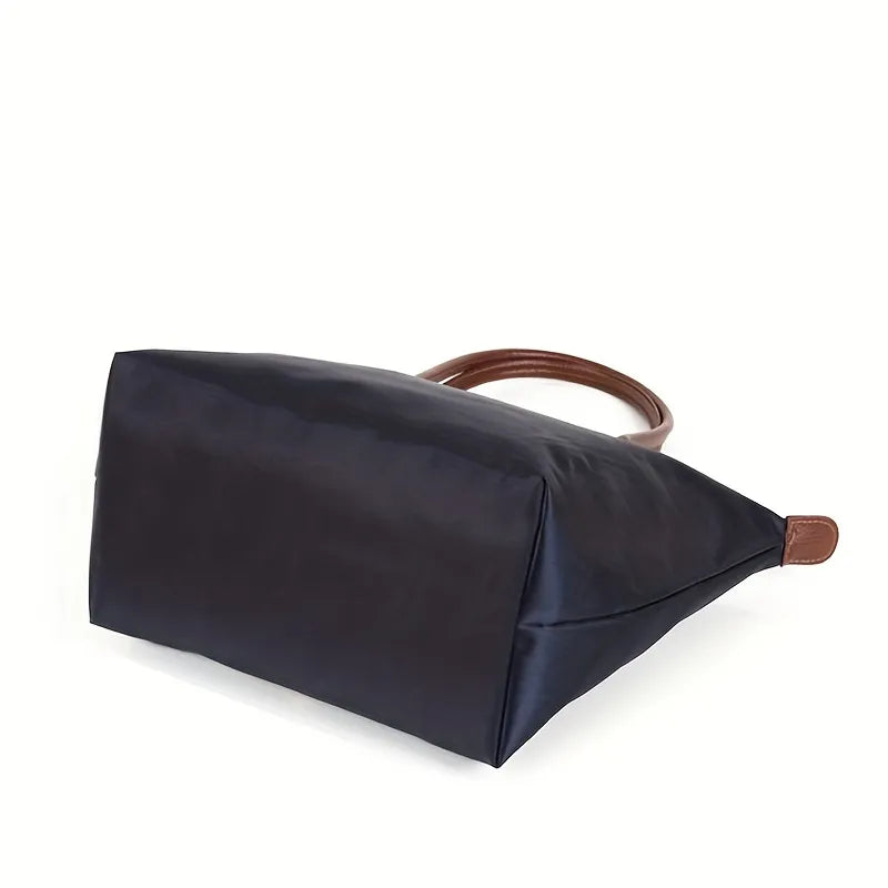 Navy structured shoulder tote with brown top handles and wide side gusset