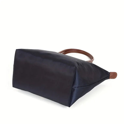 Navy structured shoulder tote with brown top handles and wide side gusset
