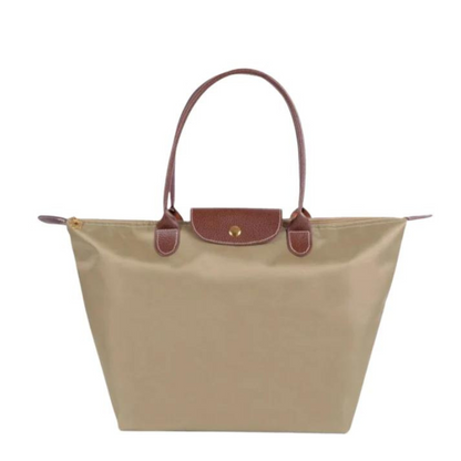 Beige structured shoulder tote with brown leather handles and front flap snap