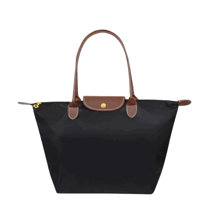 Navy structured shoulder tote with brown leather handles and front flap snap