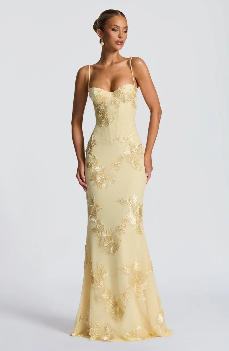 Light yellow lace maxi dress with spaghetti straps and floral embroidery, fitted.