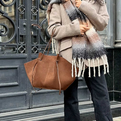 Brown suede tote bag with dual handles and open drawstring top