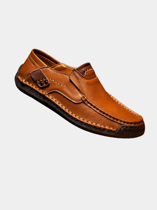 Men's tan leather loafer with moc-toe stitching and strap with metal eyelet
