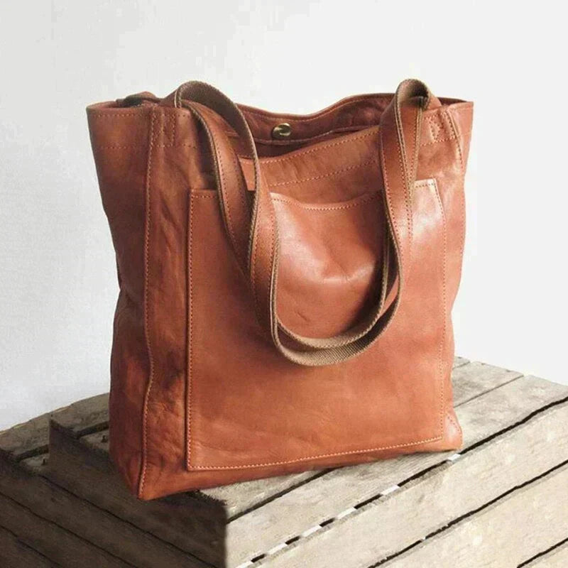 Brown leather tote bag with top handles and open top