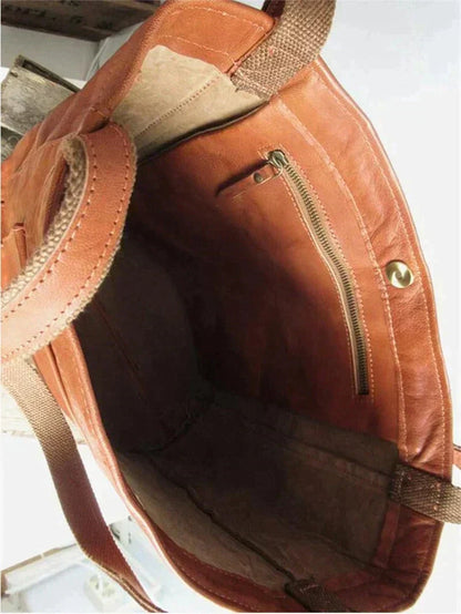 Brown leather tote bag interior with zip pocket and open top