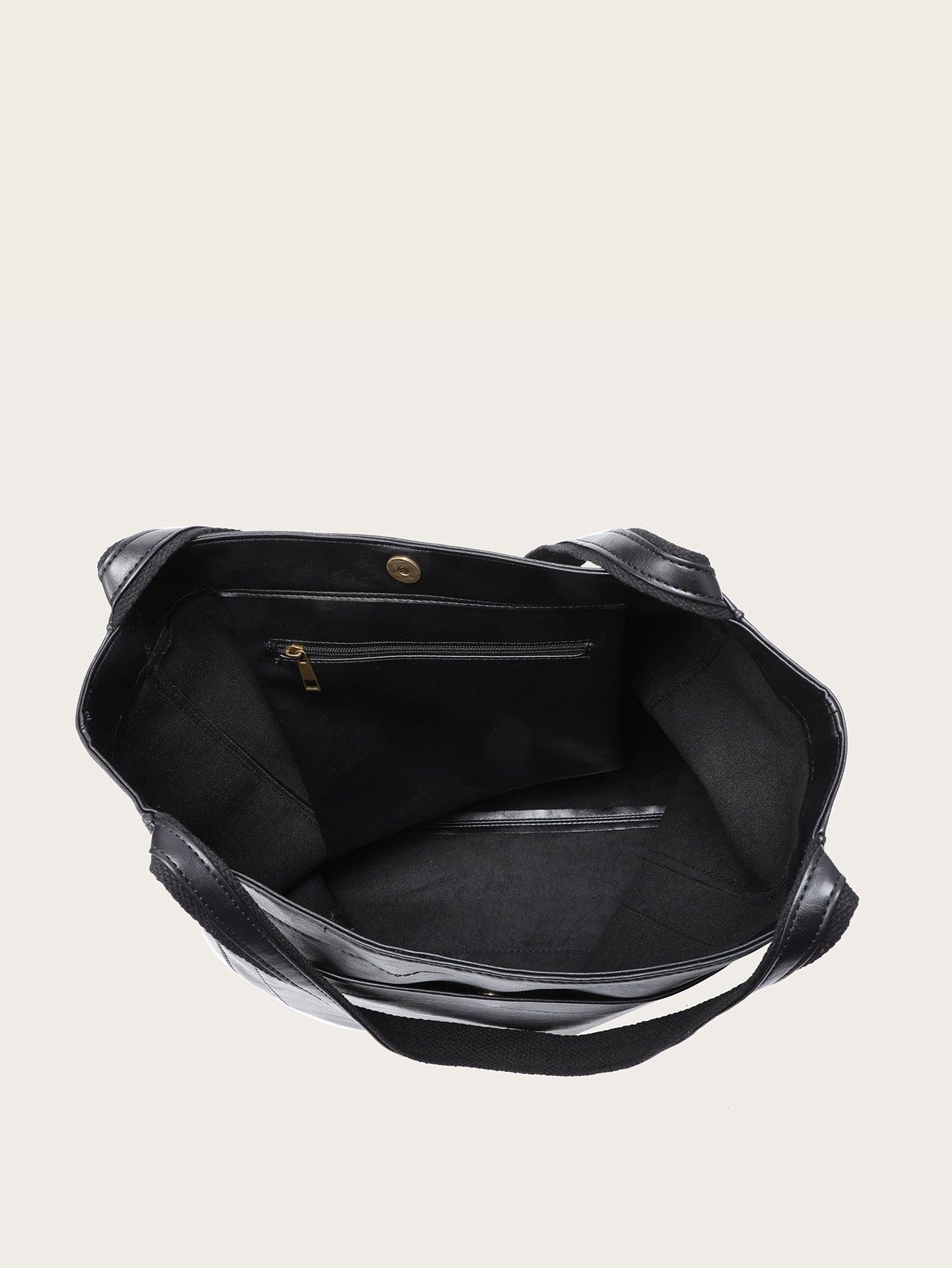 Black leather tote bag with open top and interior lining