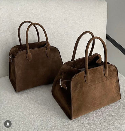 Brown suede tote handbags with top handles, shown as two side-by-side bags