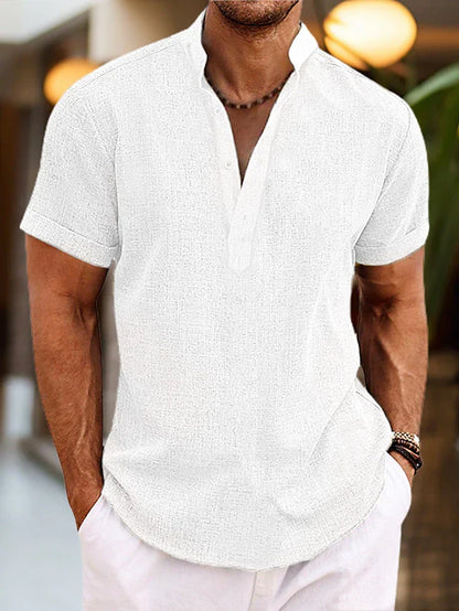 Men's white linen henley shirt with short sleeves and buttoned neckline.