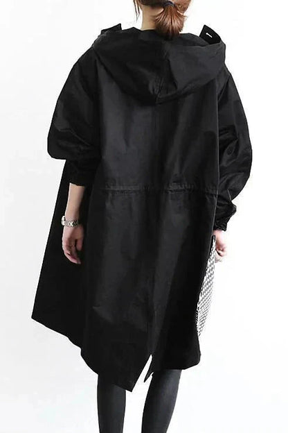 Women’s raincoat in black with oversized hood and back yoke seam, long sleeves.