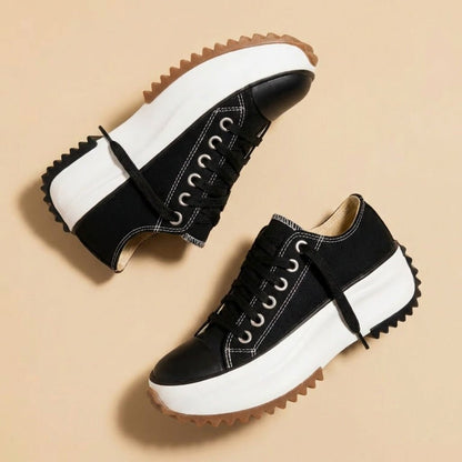 Midnight black lace-up platform sneakers, white midsole, rugged treaded outsole