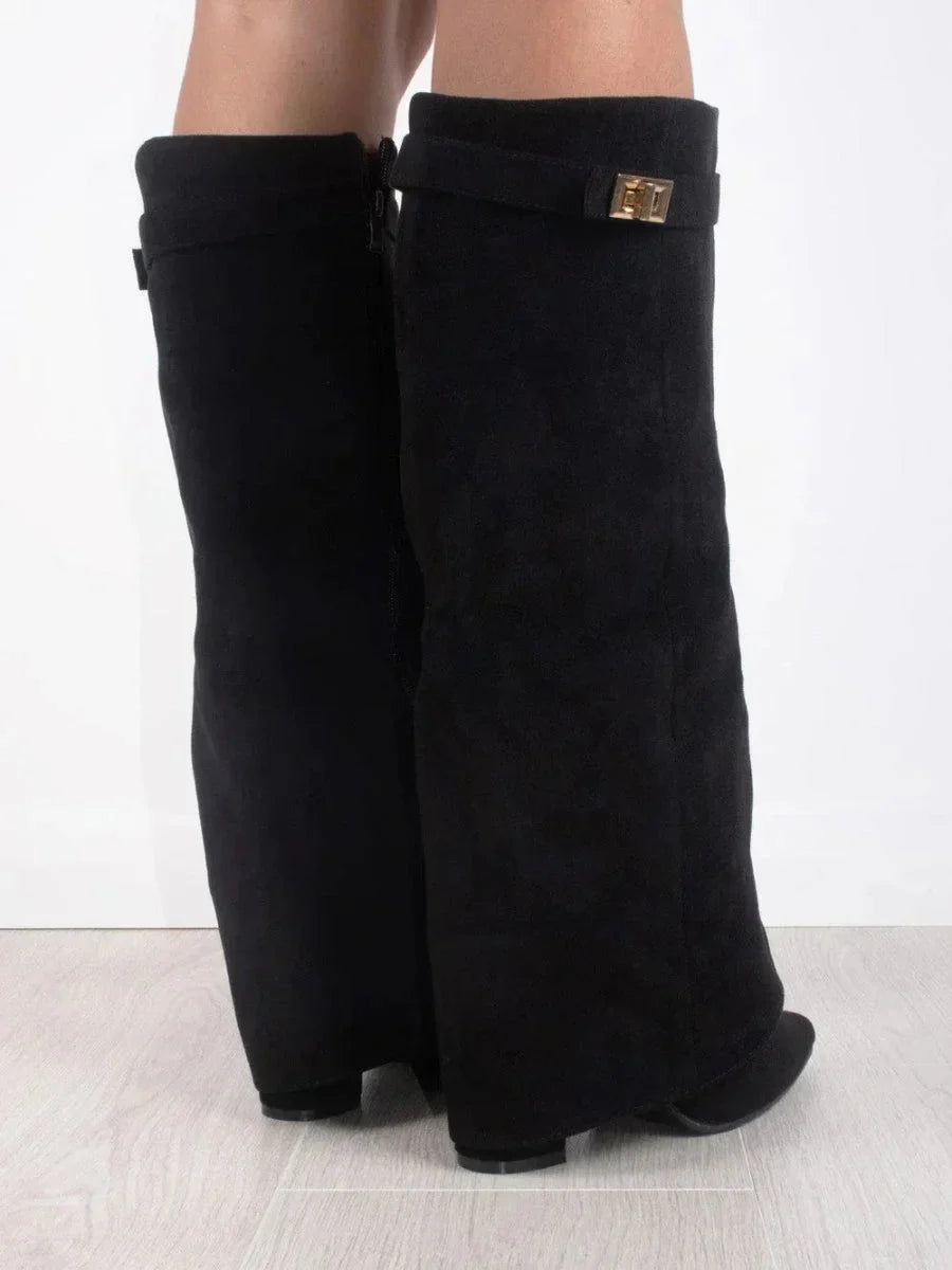 Black suede heeled knee-high boots, showing heel and square cuff buckle