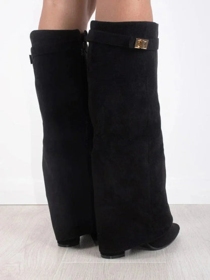 Black suede heeled knee-high boots, showing heel and square cuff buckle