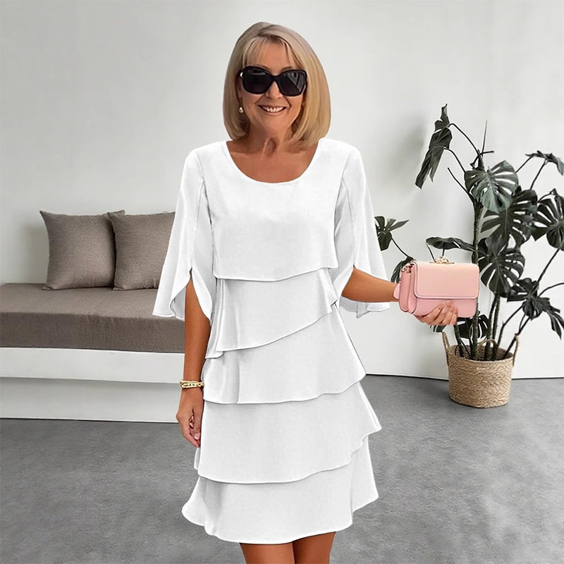White tiered puff sleeve dress with layered ruffle skirt and scoop neckline