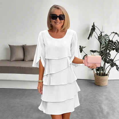 White tiered puff sleeve dress with layered ruffle skirt and scoop neckline