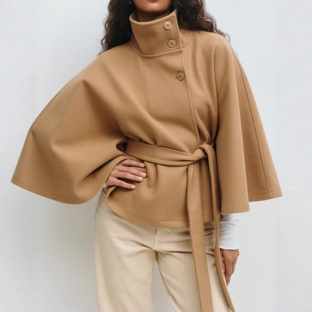 Women’s high-collar cape coat, tan, button-up with belt tie and short cape sleeves.