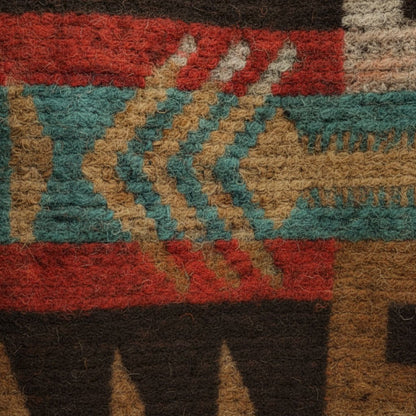 Wool jacket fabric close-up with red, teal, tan, and black geometric pattern