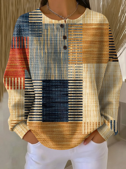 Waffle-knit henley jumper with blue, tan, and orange patchwork plaid blocks